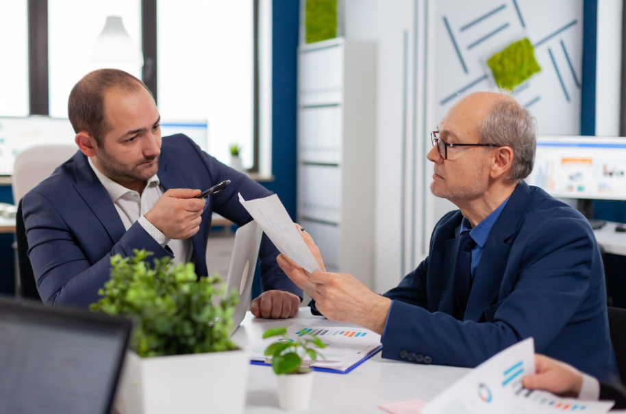 Financial advisor discussing investment strategies with a wealthy client during portfolio review.