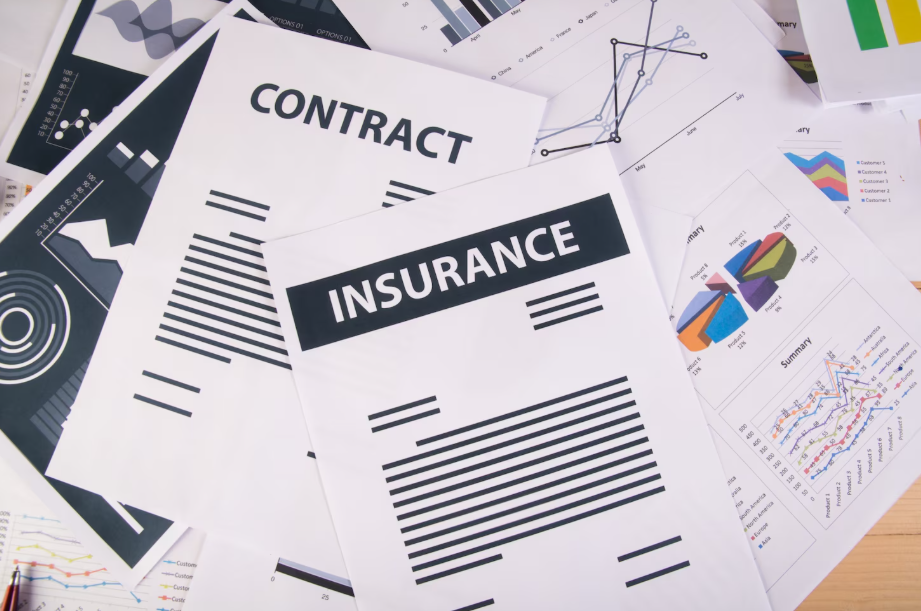 Insurance and contract documents with charts, symbolizing the role of insurance in wealth preservation
