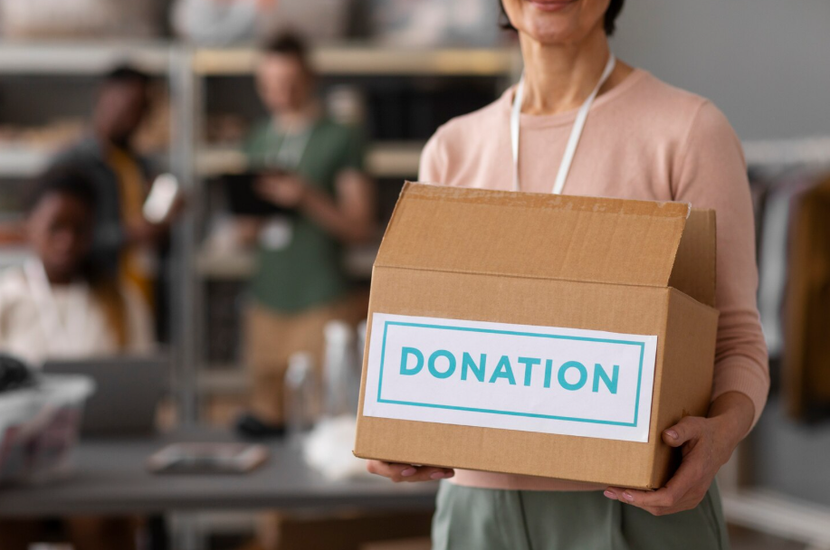 Volunteer holding a donation box, symbolizing strategic philanthropy and giving with impact