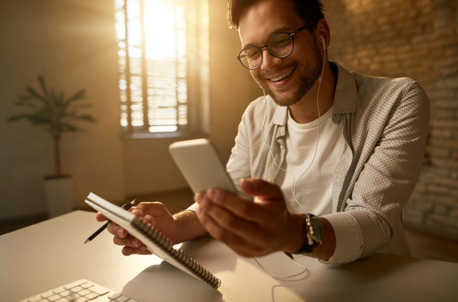 Young professional using a smartphone, symbolizing Millennials and Gen Z wealth mindset focused on digital tools and balance.
