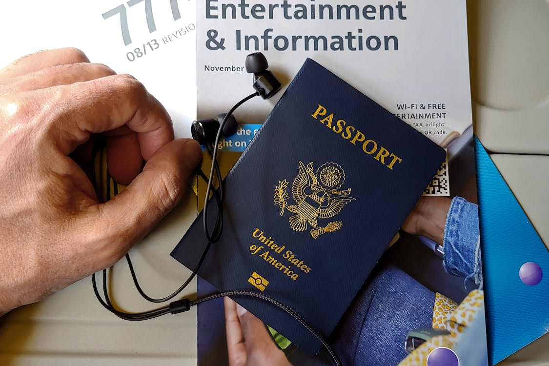 U.S. passport on an airplane seat with travel documents