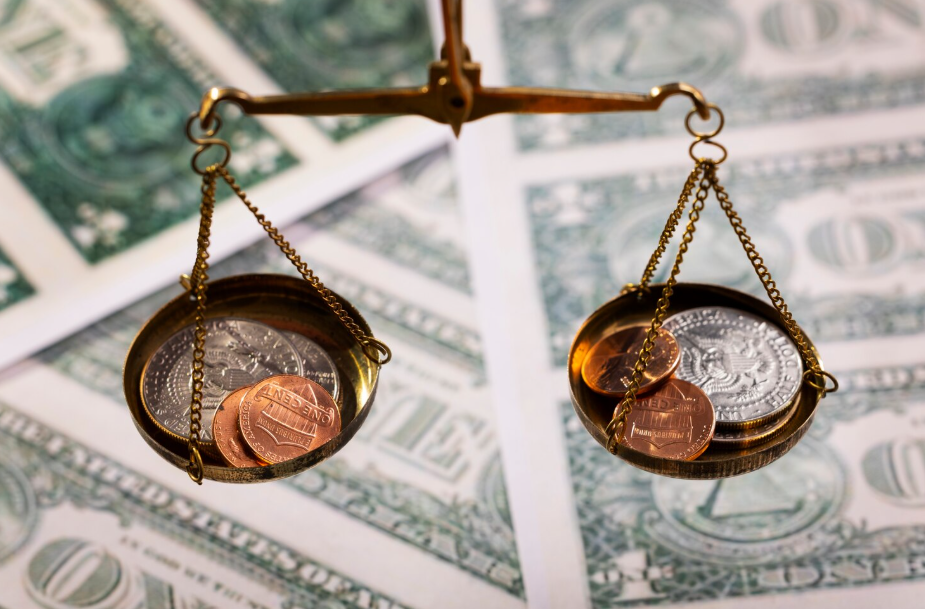 Scales balancing coins and dollars, symbolizing universal basic income and wealth distribution across society.
