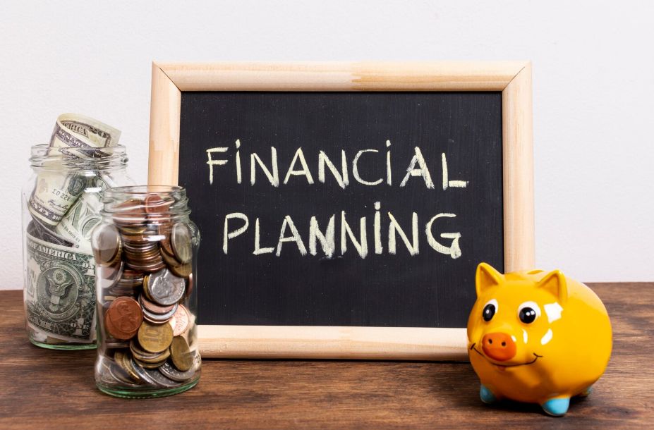 Financial planning concept with coins, dollar bills in jars, and a piggy bank beside a chalkboard.